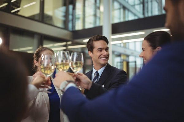 Businesspeople toasting glasses of champagne in office